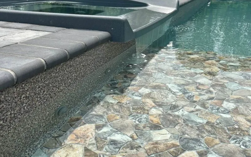 Inground pool with a water feature - Puravida Custom Pools