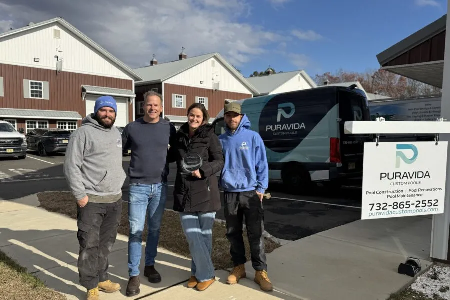 Puravida Custom Pools staff with awards logo